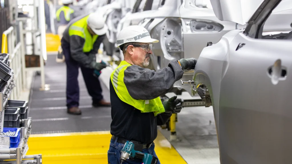 an automotive manufacturing employee works the line at Mazda Toyota Manufacturing's plant, in Huntsville, Alabama