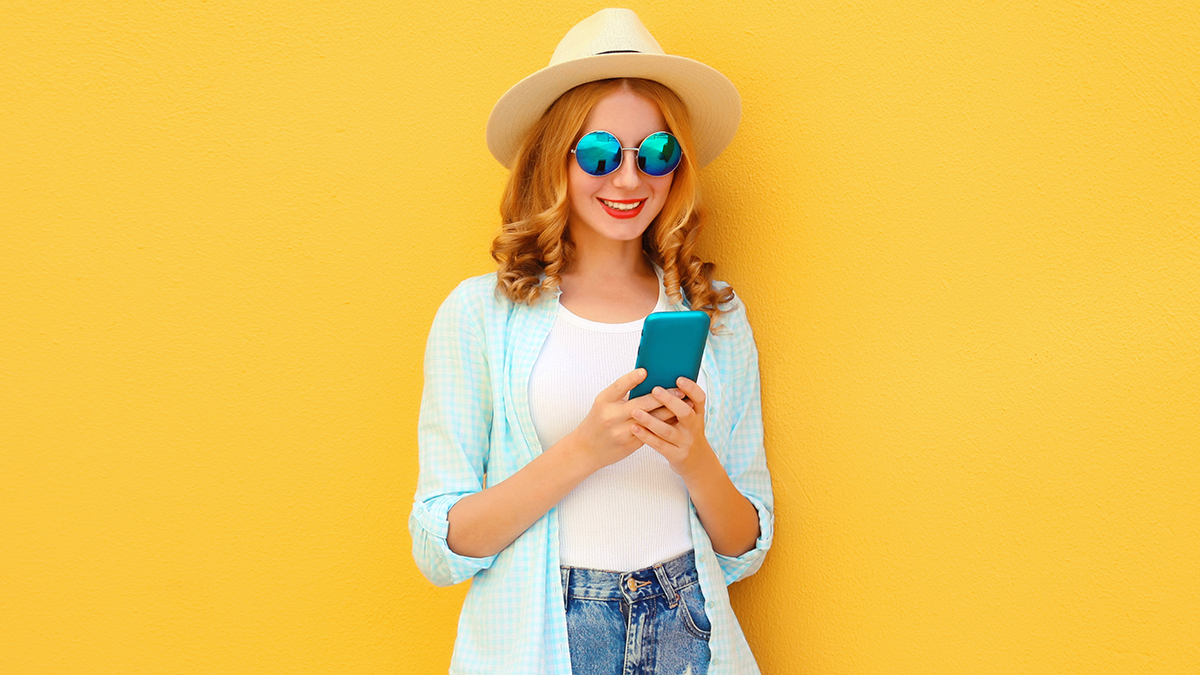 Smiling woman using a smartphone with AI booking travel