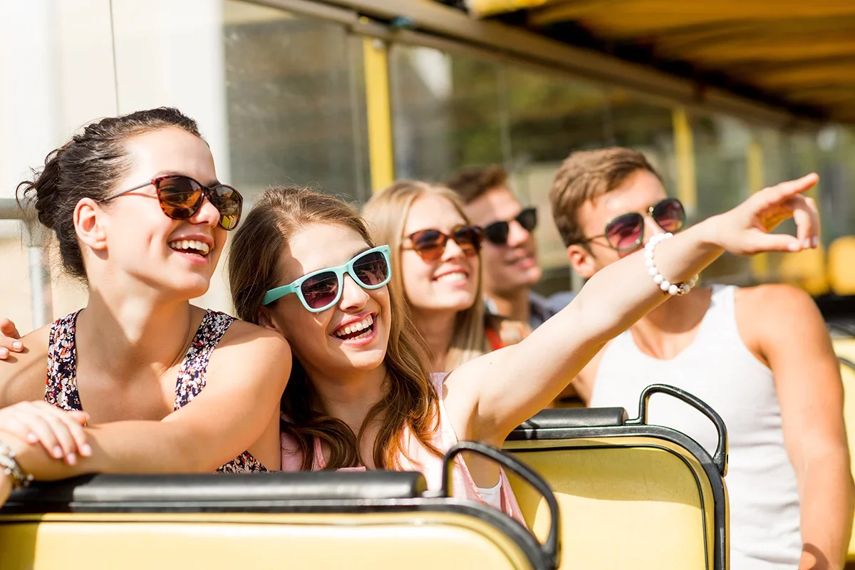 visitors smile on a bus tour, representing the increased visitors an expert tourism marketing agency can deliver